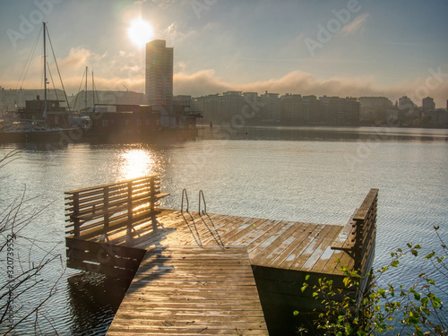 pier and view of silhoetted cityscape photo