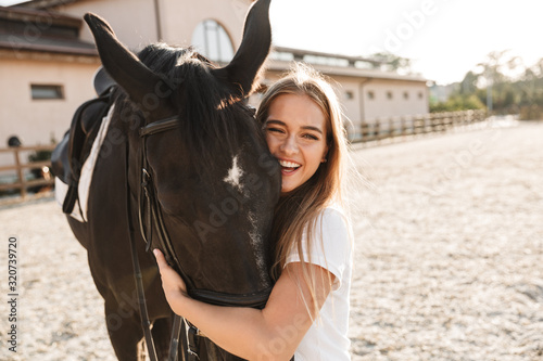 Beautiful woman with horse in countryside