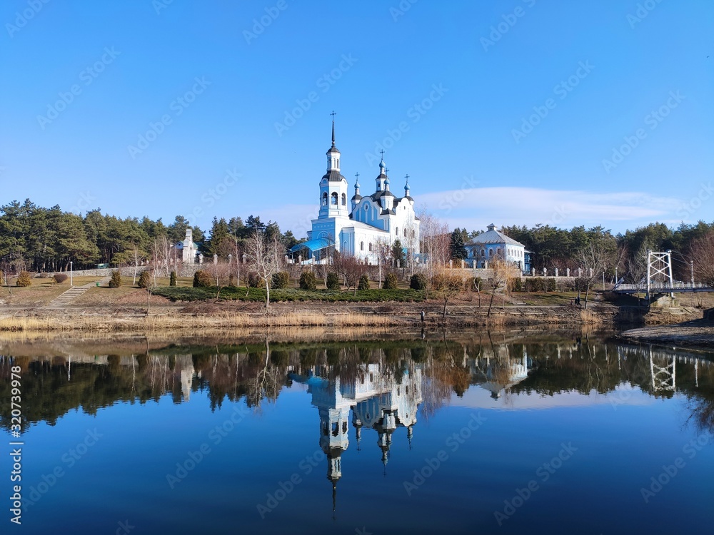 Christian Cathedral on a background of blue sky in reflection of water