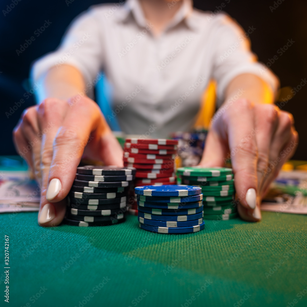 A player in a casino raises bets with chips, poker and a gaming business. The concept of a gaming business and online casino A player in a casino raises bets with chips, poker and a gaming business. The concept of a gaming business and online casino
