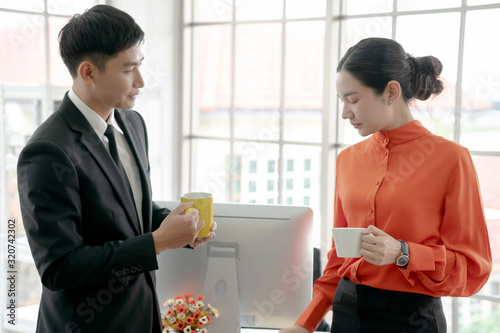 Businesswoman talking to colleague in office