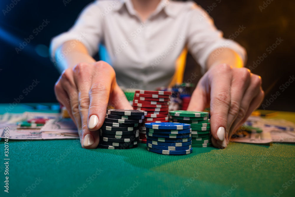 A game in a casino, a player plays poker, raising bets, risk. A business game