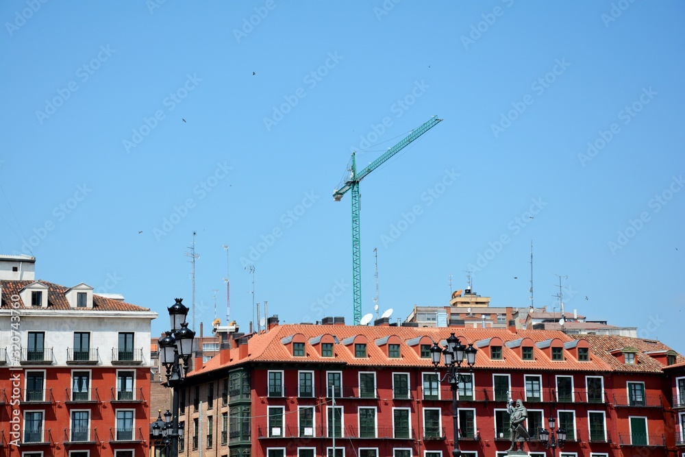 crane and buildings against blue sky