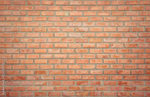 Old Orange brick wall concrete or stone texture background, wallpaper limestone abstract to flooring and homework/Brickwork or stonework clean grid uneven interior rock old. Copy space.