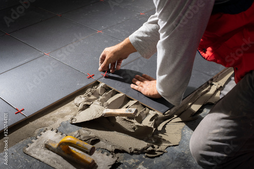 Floor ceramic tiles installation. Create, arranging.