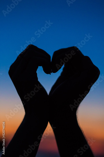 Valentine s Day celebration. Heart sign made by hands  lovers. Valentine Couple. Happy Family. Love Concept  romantic background  Soft focus