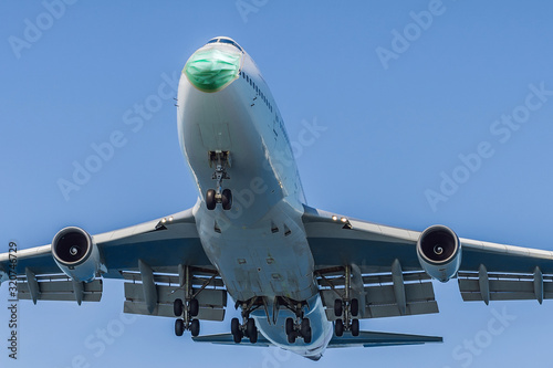 The plane is landing in a medical mask. Coronovirus protection. Removing people from infected China. People transport coronovirus in an airplane
