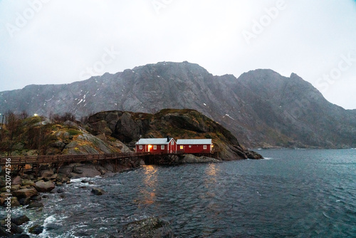 Old red fisherman's house on a cliff. Lofoten islands, Norway.