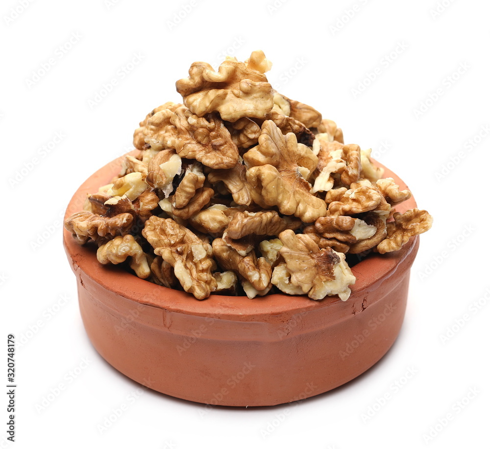 Unshelled walnuts in clay bowl isolated on white background Unshelled walnuts in clay bowl isolated on white background