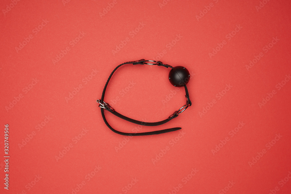 top view of black gag isolated on red top view of black gag isolated on red