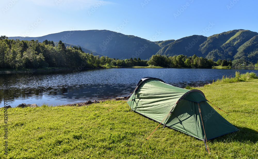Camping tent at sunrise set up by the Lake Haukeland (Haukelandsvatnet) in Bergen, Norway.