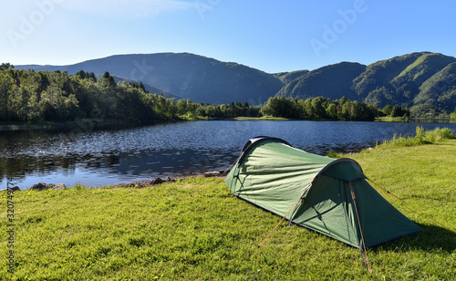 Camping tent at sunrise set up by the Lake Haukeland (Haukelandsvatnet) in Bergen, Norway.