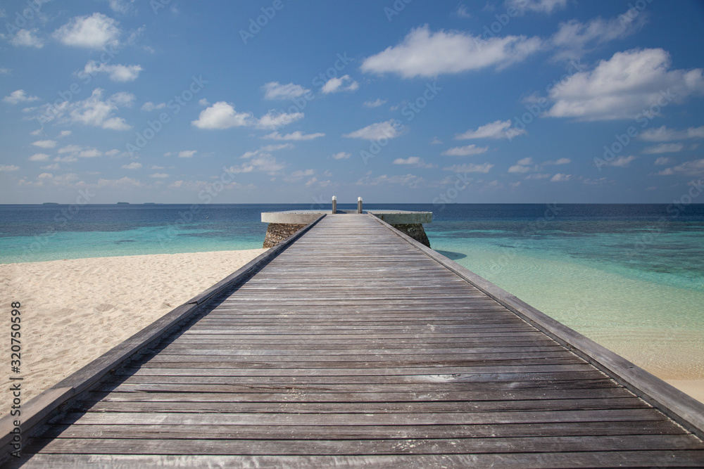 pier overlooking the sea, wooden bridge on one of the islands in the Maldives pier overlooking the sea, wooden bridge on one of the islands in the Maldives