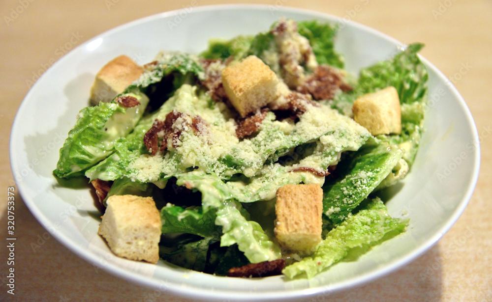 Caesar salad on wooden table, High angle view Caesar salad on wooden table, High angle view
