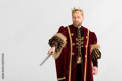 king with crown pointing with sword isolated on grey