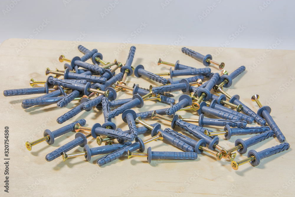 Dowel nails on wood background. Set of wall plugs. Dowel nails on wood background. Set of wall plugs.