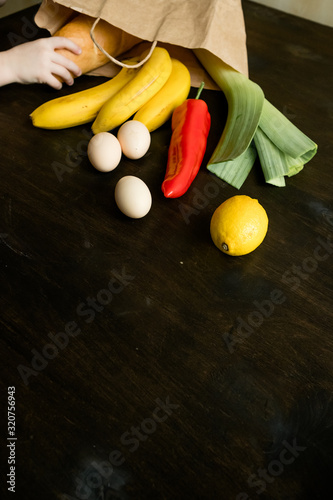 set of eco products products on the table in eco bag.On the table is a loaf, eggs, red peppers, bananas, lemon, loaf