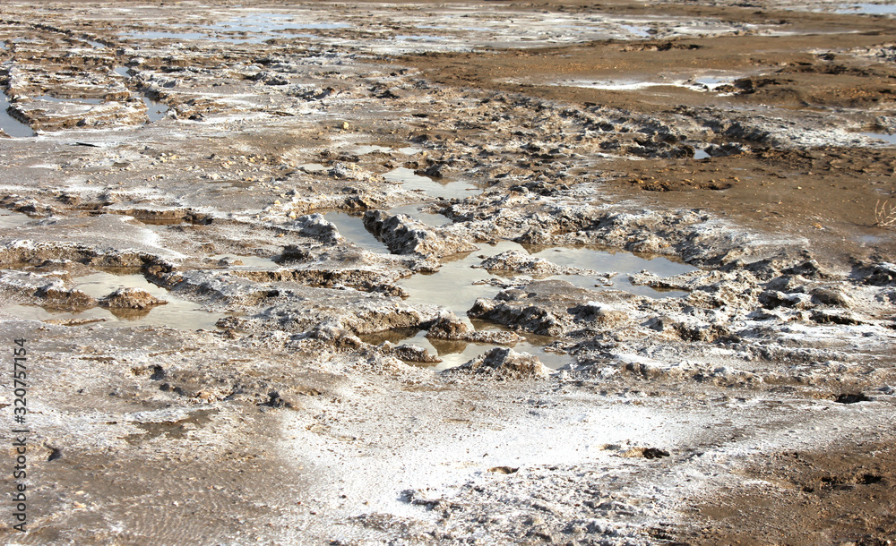 Salted mud and puddles on shore lake Baskunchak Salted mud and puddles on shore lake Baskunchak
