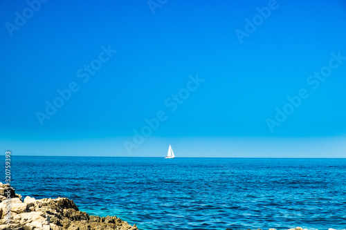Seascape on the island of Dugi Otok archipelago in Croatia, Adriatic sea in summer, yachts on the horizon