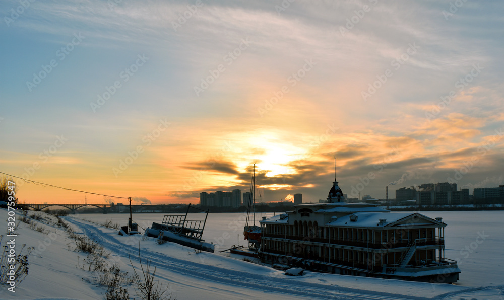 sunset over a frozen river in the city
