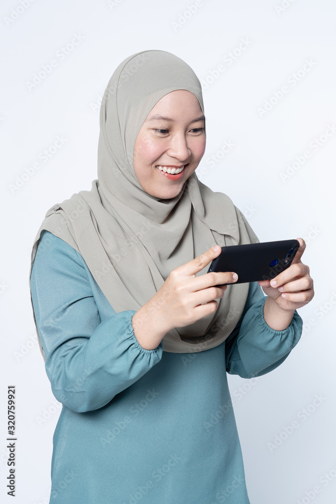 Muslim female using her mobile phone.