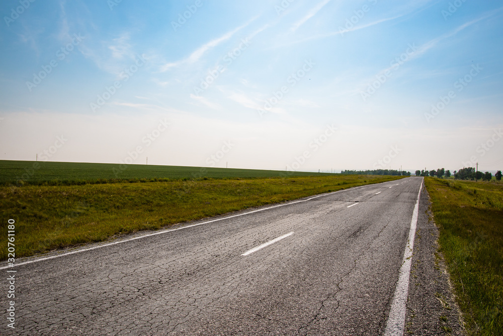 asphalt road goes far into the horizon