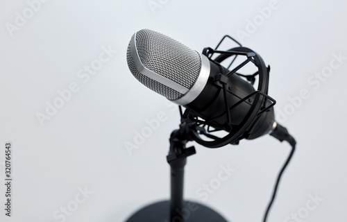 technology and audio equipment concept - close up of microphone on white background