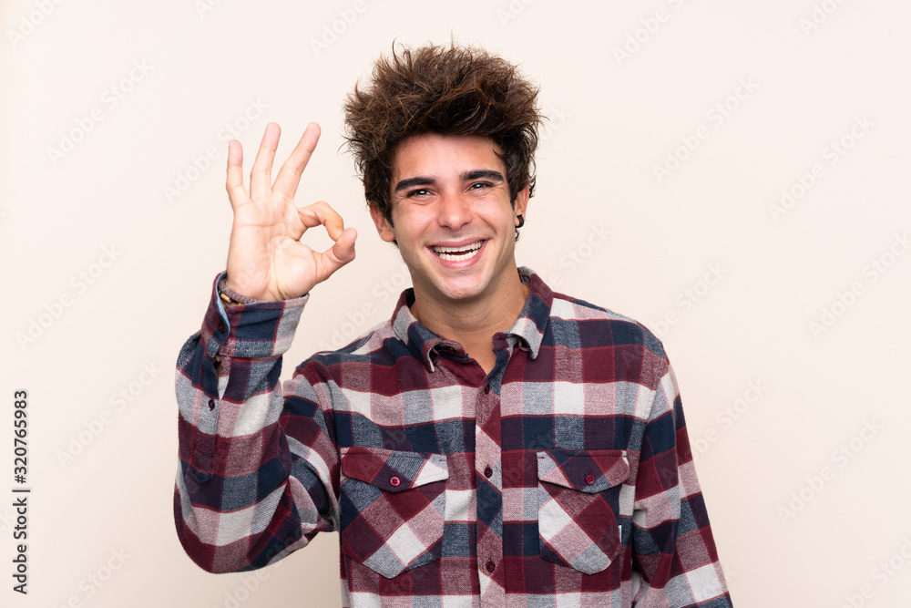 Young caucasian man showing ok sign with fingers Young caucasian man showing ok sign with fingers