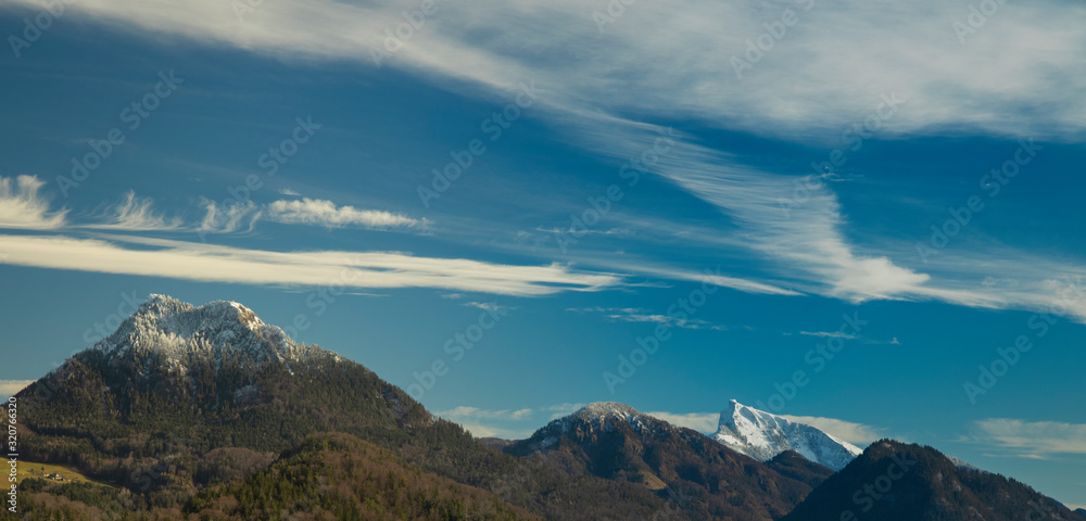 picturesque majestic Alps mountains ridge panoramic scenic view winter time snowy peak landscape wallpaper pattern with blue sky white cloud background empty copy space for your text here