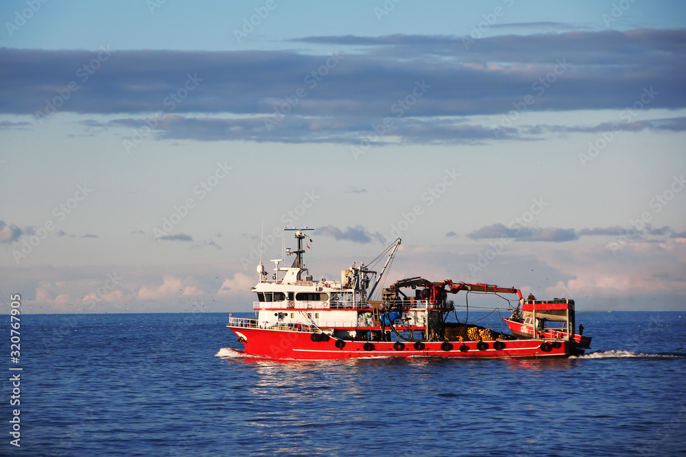 Red loading boat with cargo in Black sea Red loading boat with cargo in Black sea