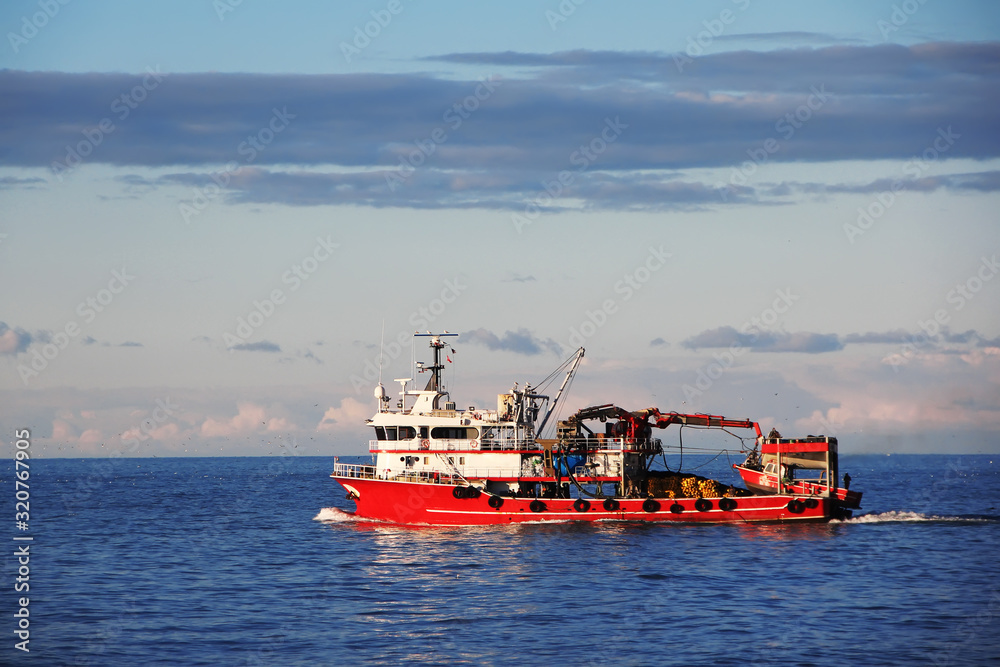 Red loading boat with cargo in Black sea