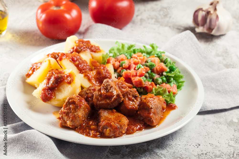 Braised pork meat stew served with potatoes Braised pork meat stew served with potatoes