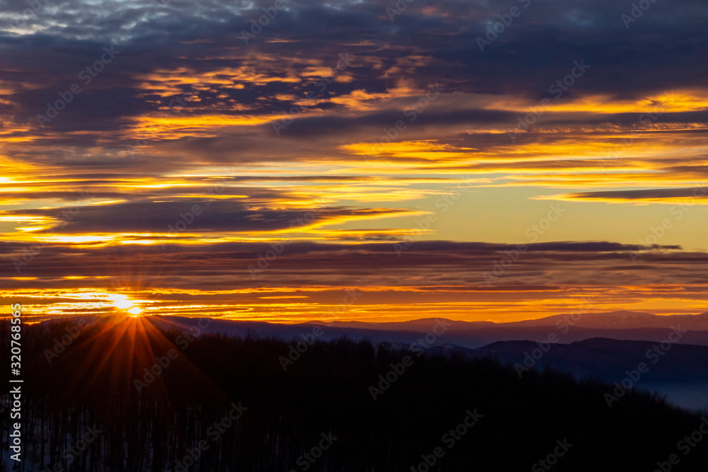 Fototapeta premium Spectacular sunset sky over the mountain, snowy winter view from the Kopitoto Hill, Vitosha Mountain, Sofia, Bulgaria