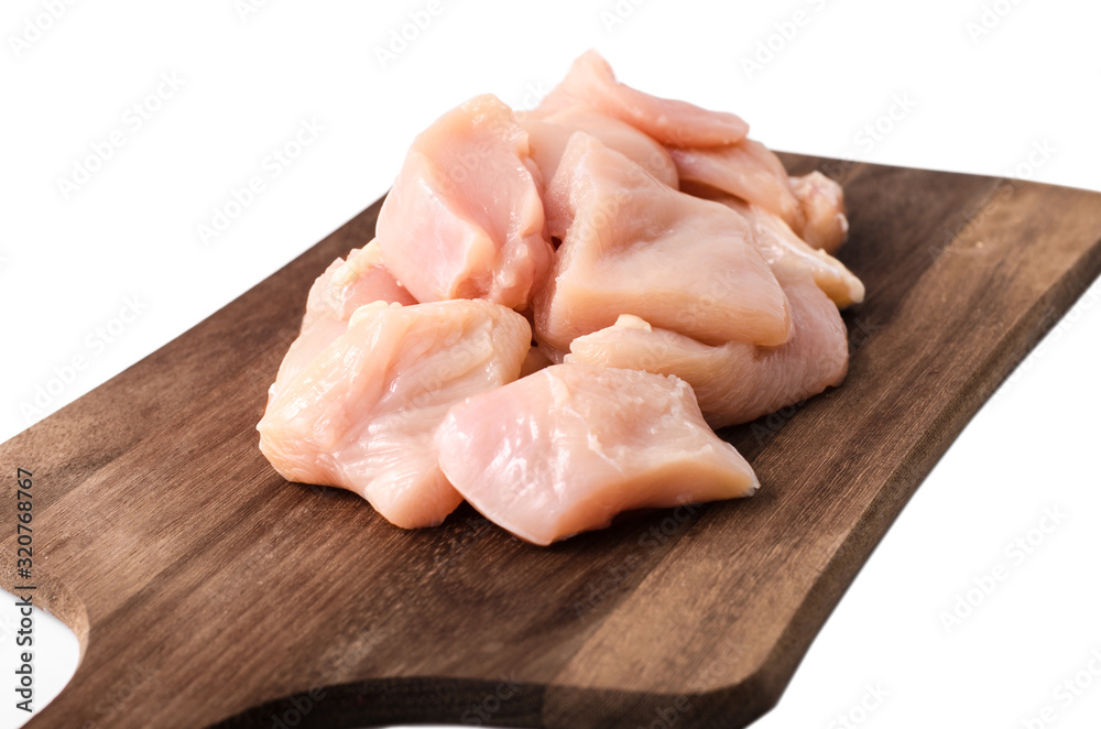 Sliced pieces of chicken lie on a wooden board on a white background
