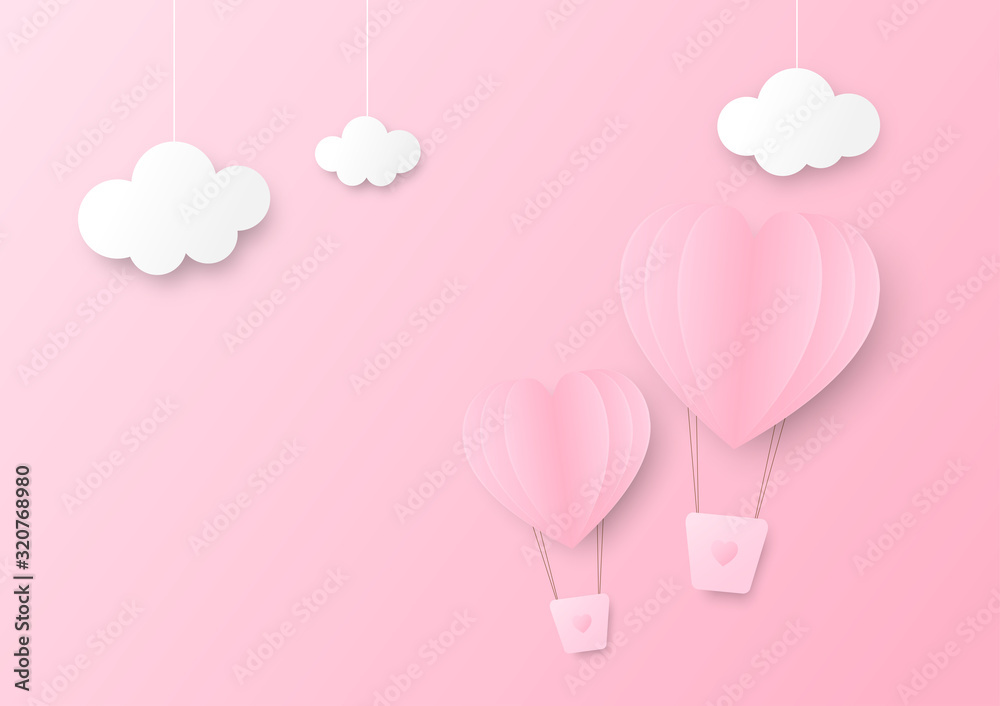 Pink paper heart shape balloon floating in the sky with three clouds hang on top.
