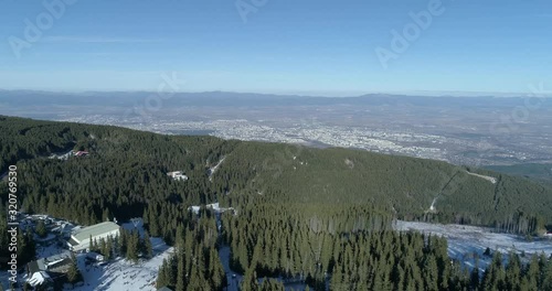 panoramic view of snow mountain and city at background