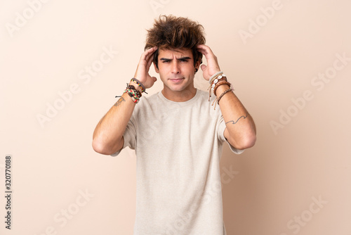 Young caucasian man over isolated background unhappy and frustrated with something. Negative facial expression