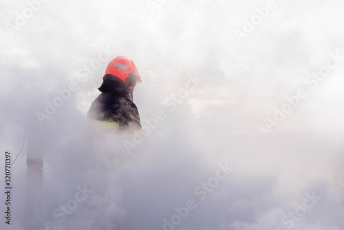 firefighter in thick smoke during a fire