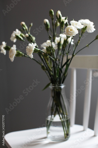  white clove carnations bouquet in a vase