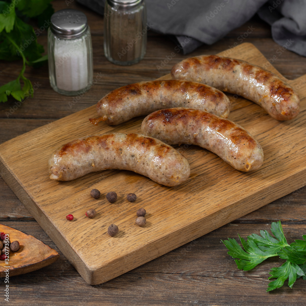 Grilled sausages on a wooden Board on a wooden table table Grilled sausages on a wooden Board on a wooden table table