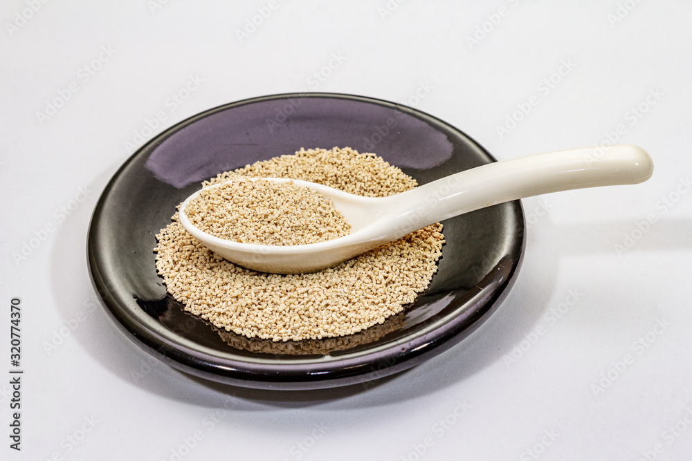 Dashi, traditional Japanese seasoning isolated on white background. Indispensable ingredient for cooking soup stock. Finished dry granules Dashi, traditional Japanese seasoning isolated on white background. Indispensable ingredient for cooking soup stock. Finished dry granules