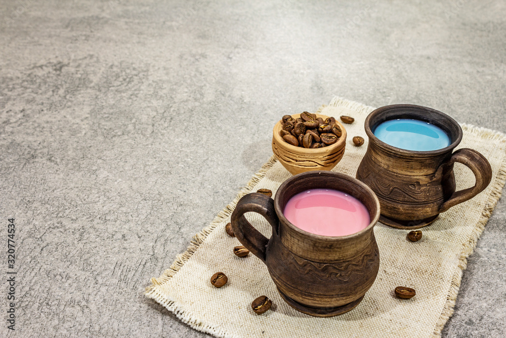 Trendy drink blue and pink latte. Lavender or spirulina and rose, beetroot or raspberry coffee. Stone concrete background Trendy drink blue and pink latte. Lavender or spirulina and rose, beetroot or raspberry coffee. Stone concrete background