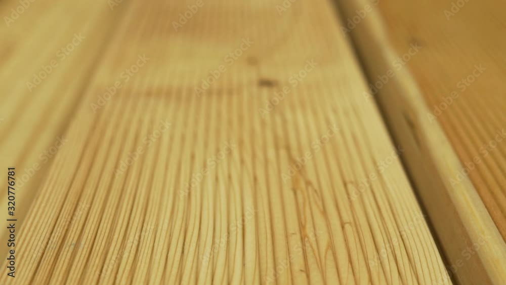 Close-up of a fresh cut of a wooden Board made of natural wood at a woodworking plant factory. Camera slide