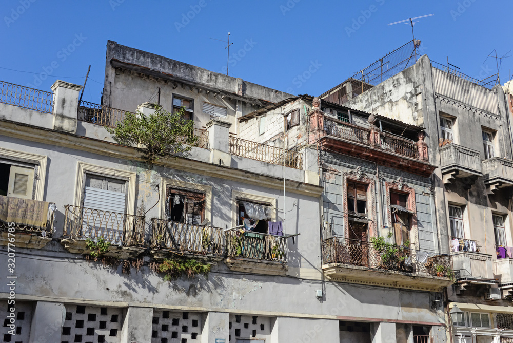 Old facade of houses with balconies on the street in Havana, Cuba