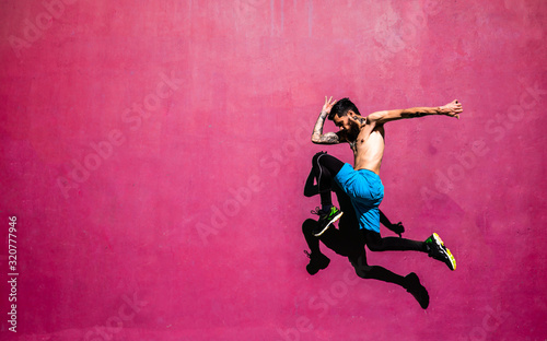 Fototapeta Naklejka Na Ścianę i Meble -  boy jumping, throwing flying knee.