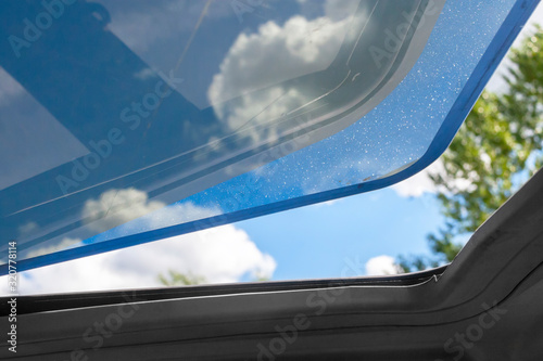 the open hatch in a car roof in hot summer day