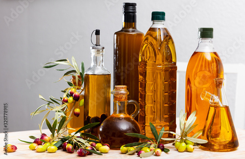 Olive oil in bottles on wooden table