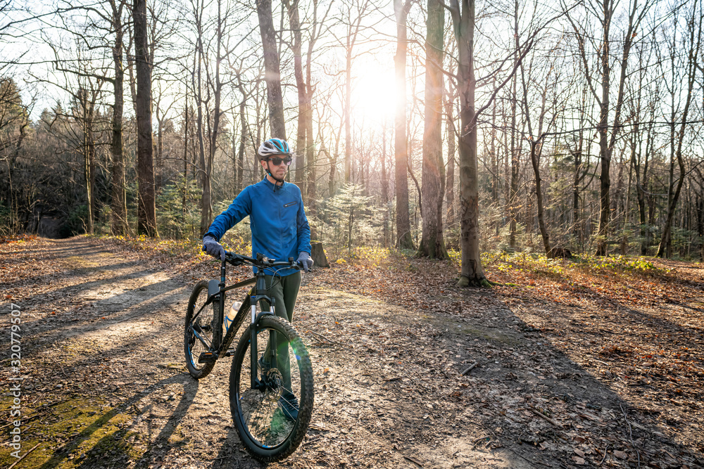 Guy on his mountain bike in forest. Sport fitness motivation and inspiration outdoors