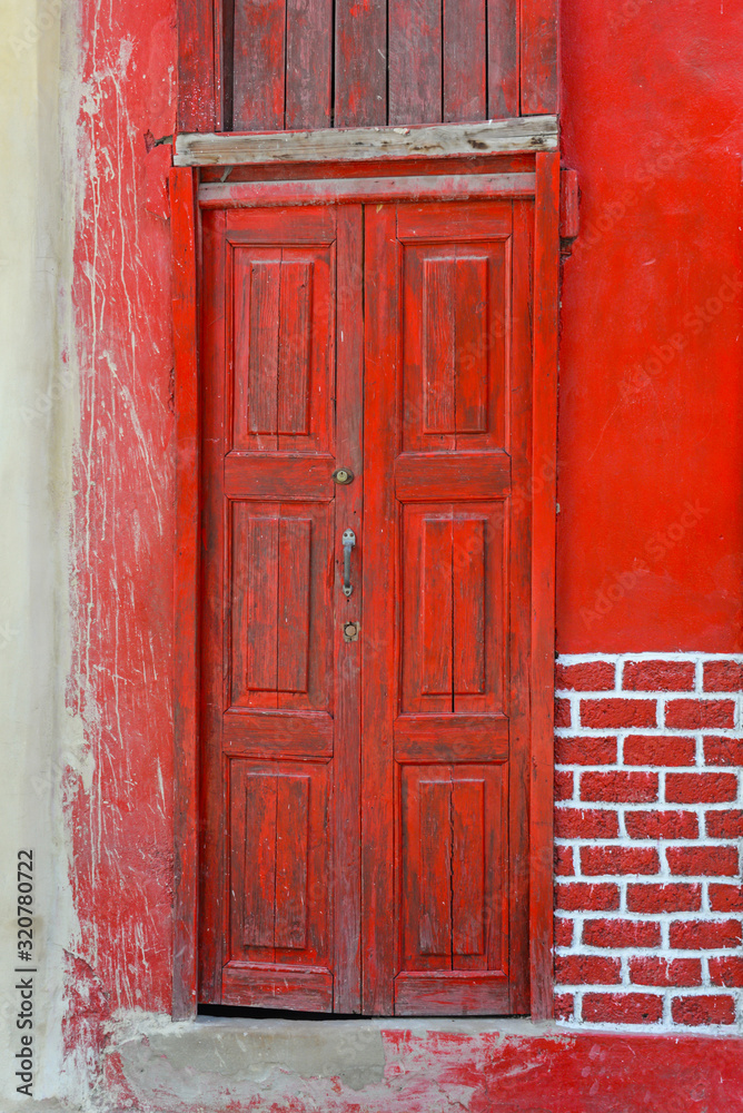 Old red door of a house in Havana, Cuba