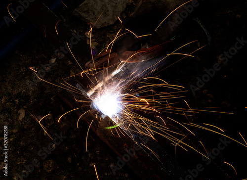 sparks from metal welding at a construction site